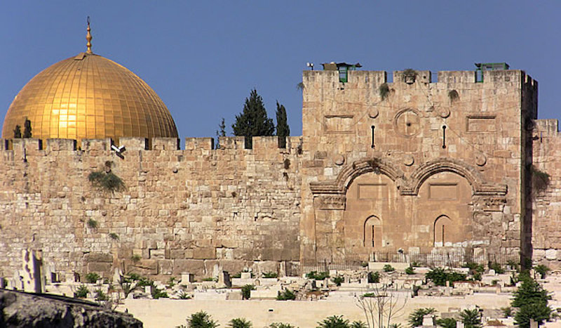 Eastern Gate with Muslim graves before the gate with top of the Dome of the Rock in the background.